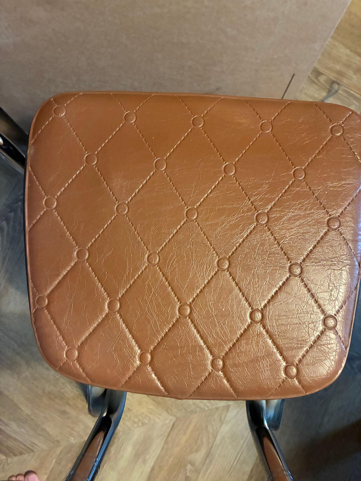 Armchair with armrests from the 70s in Skai and chrome.