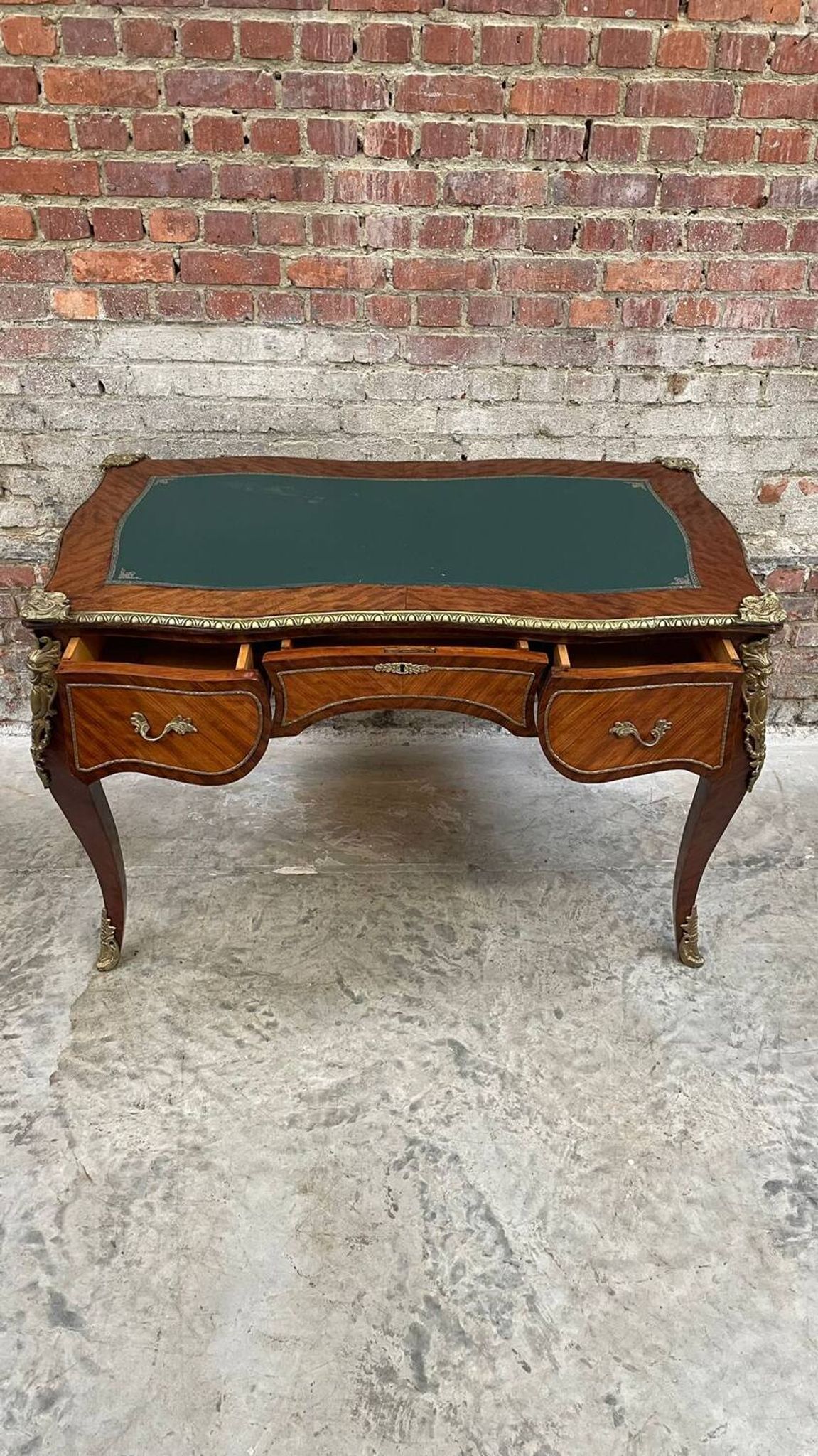 Antique French-style desk with green leather top and bronze mounts