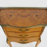 Baroque style wooden chest of drawers with bronze frieze.