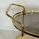 Italian oval rolling table in brass and lacquered wood.