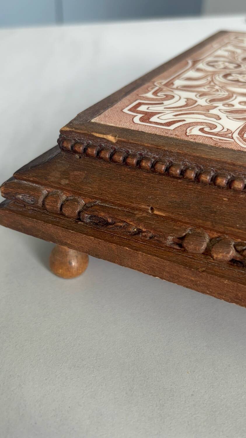 Vintage wooden and antique earthenware trivet, brown tile design