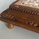 Vintage wooden and antique earthenware trivet, brown tile design