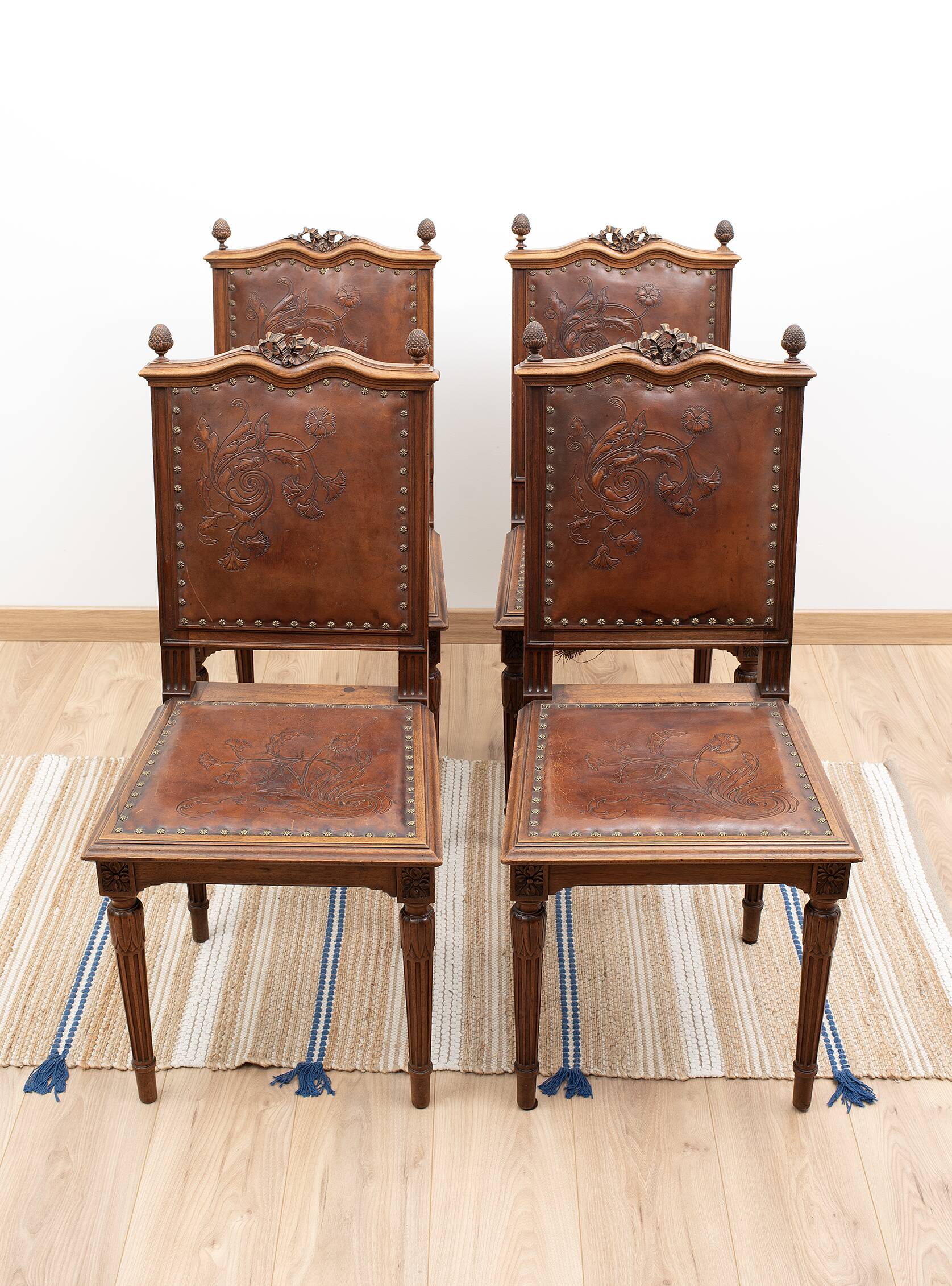 Set of 4 Louis XVI style chairs in carved wood and embossed leather.