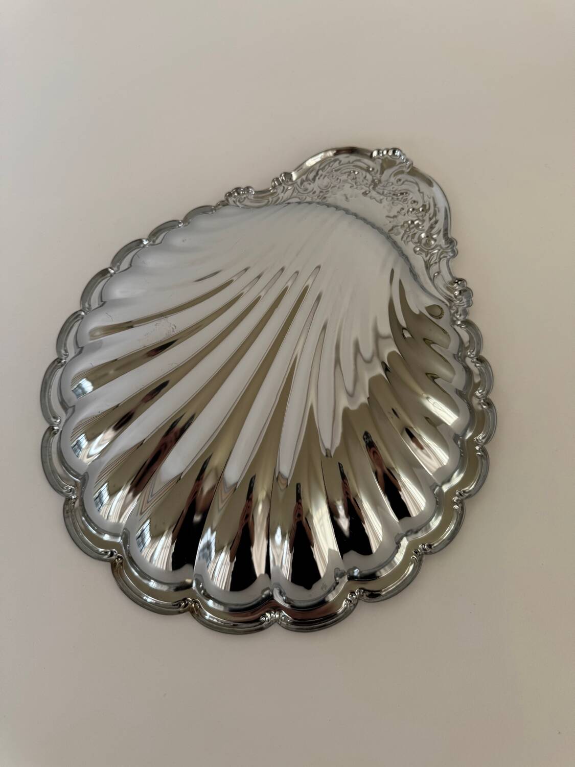 Large silver-plated serving dish in the shape of a vintage shell.