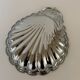Large silver-plated serving dish in the shape of a vintage shell.