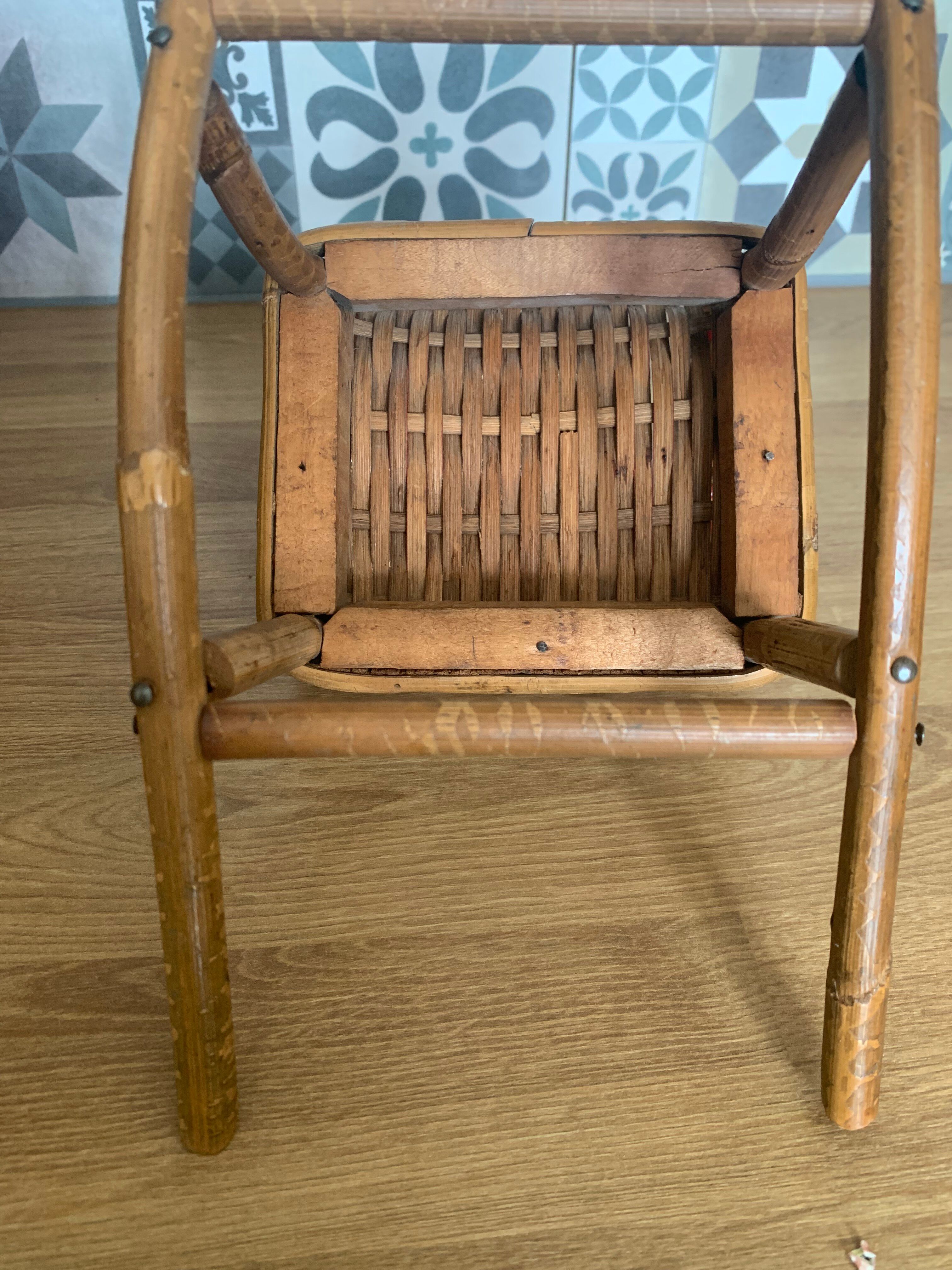 Antique miniature rocking chair in rattan for dolls.