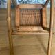 Antique miniature rocking chair in rattan for dolls.