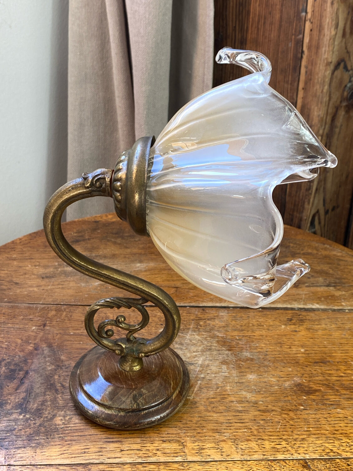 Bronze and glass wall light in the shape of a flower.