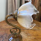 Bronze and glass wall light in the shape of a flower.