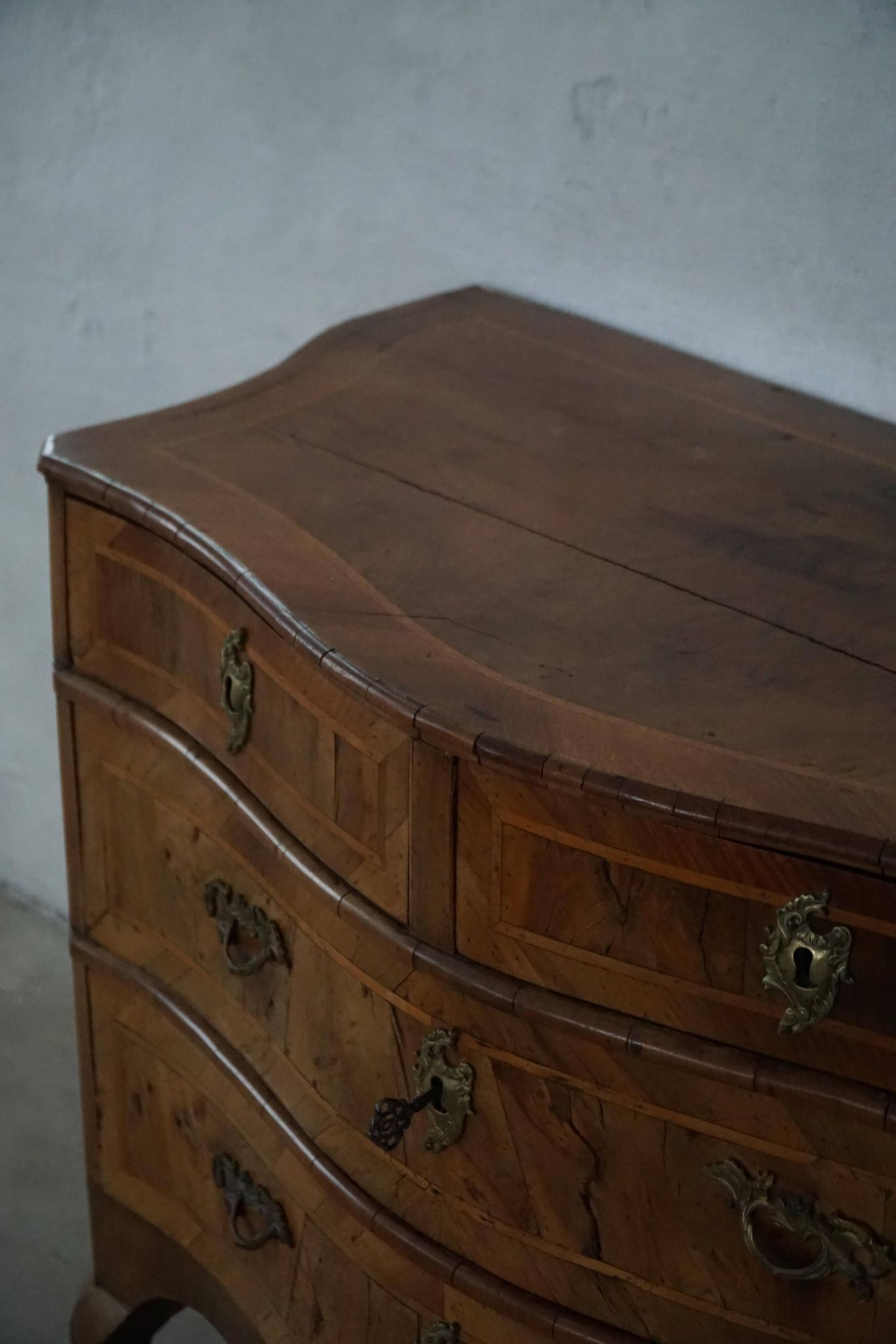 18th century, antique Danish baroque serpentine chest of drawers in walnut.