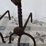 Vintage metal and cast iron fire dogs with shell motif.