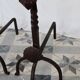 Vintage metal and cast iron fire dogs with shell motif.