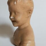 Bust of a small child in ancient plaster