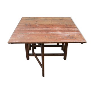 Ancienne table à manger en pin du début du XIXe siècle avec un pied de porte en forme de feuille