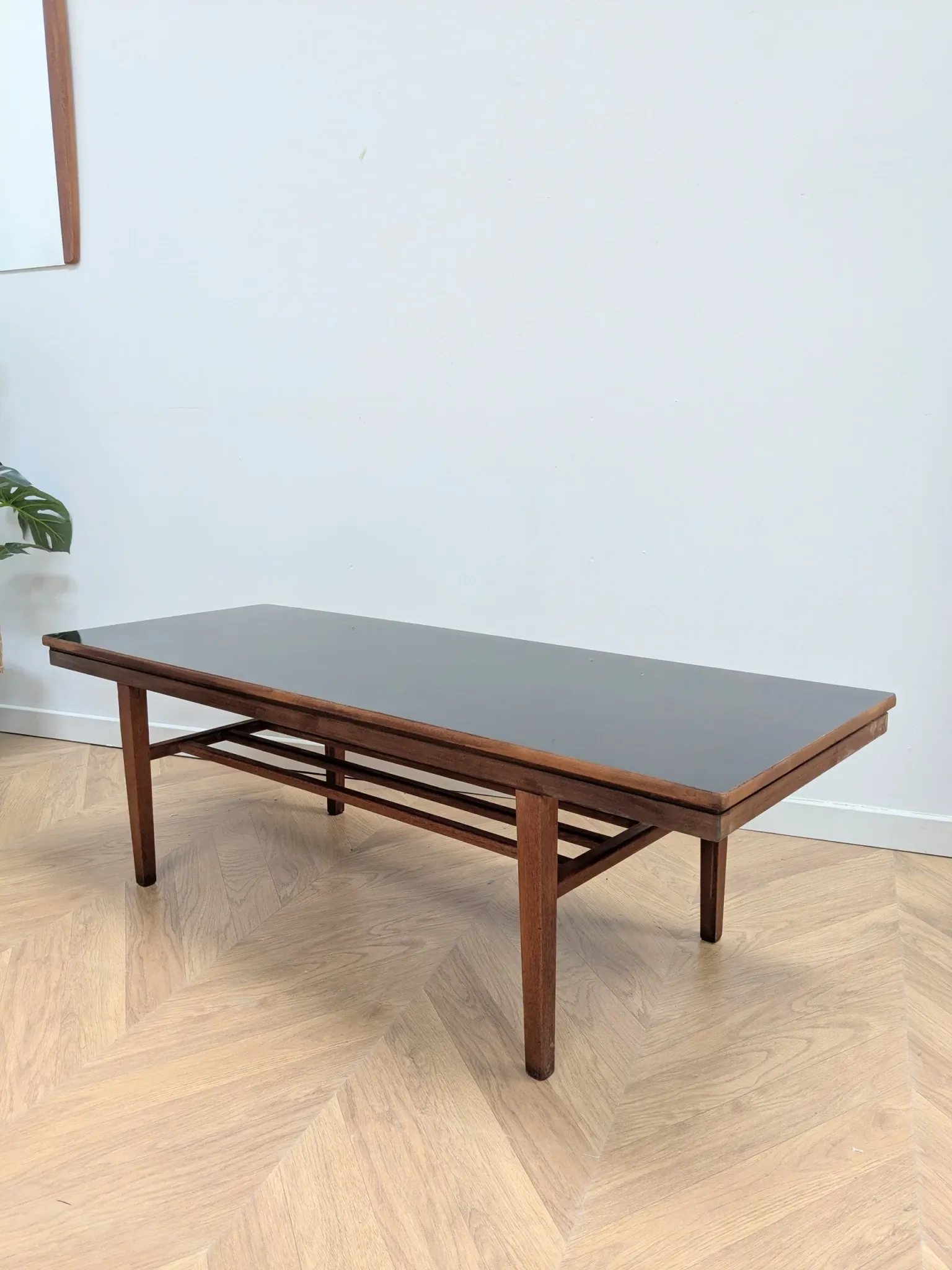 Vintage Danish coffee table in teak with a black top from the 1960s.