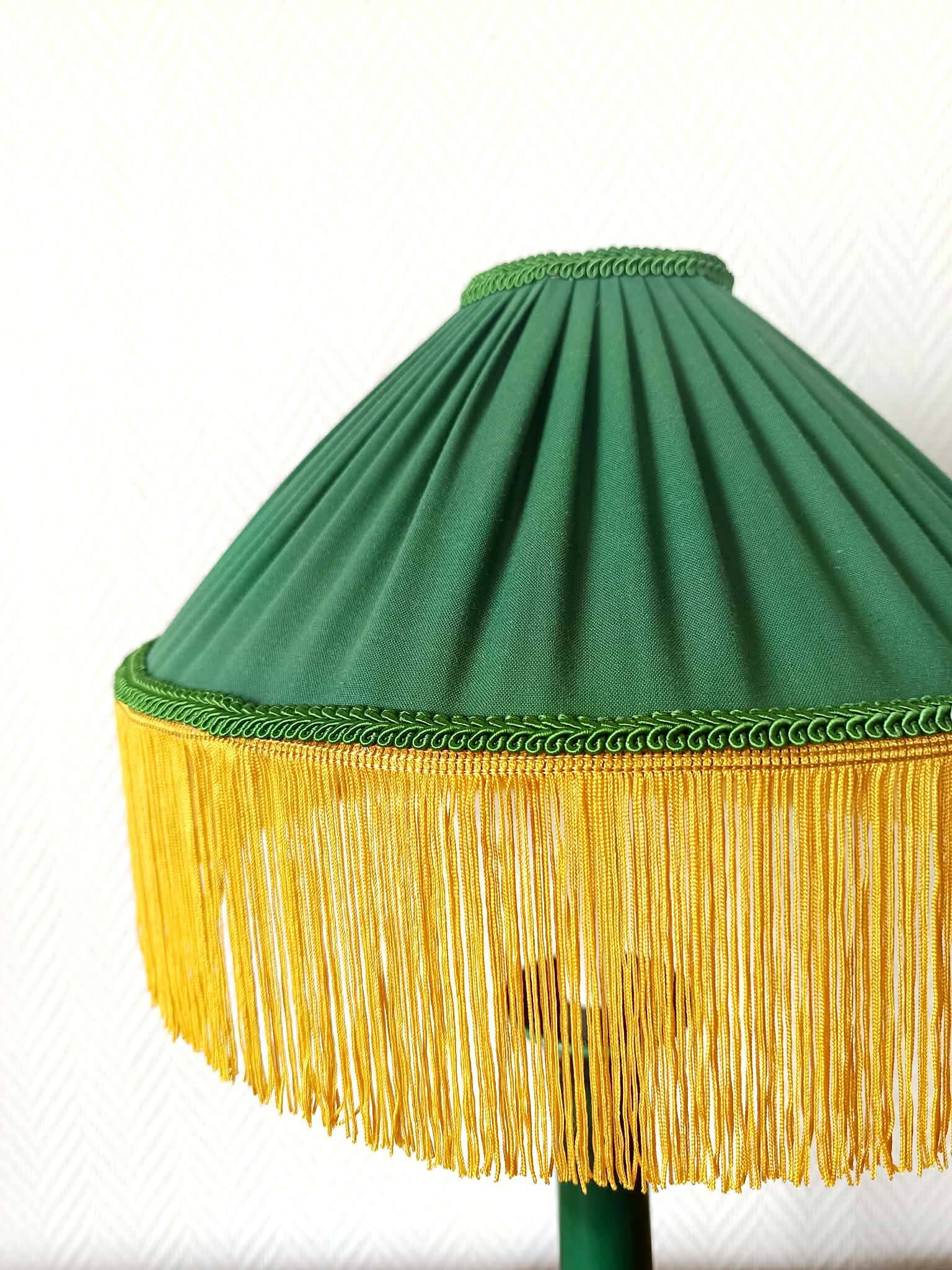 Green ceramic lamp with a vintage pleated fringe shade.