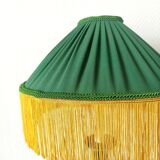 Green ceramic lamp with a vintage pleated fringe shade.