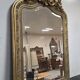 Large carved and gilded wooden mirror, rectangular in shape.