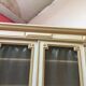 Bookcase 2 painted in ochre and cream mesh doors beginning 20 th