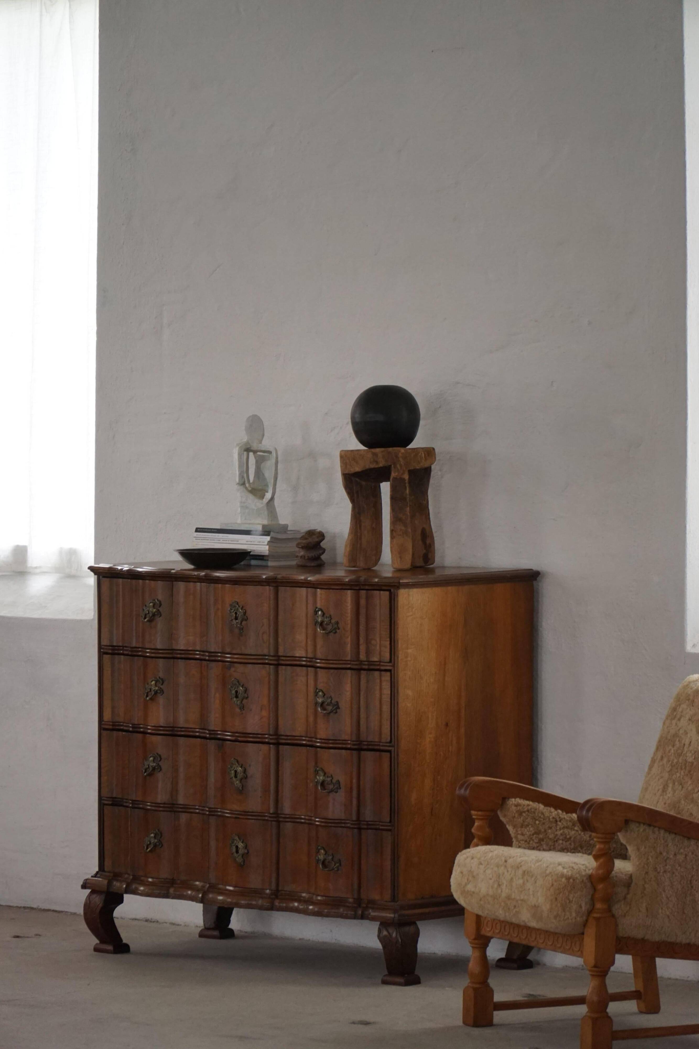 Antique baroque oak commode from the late 18th century with cabriole legs.