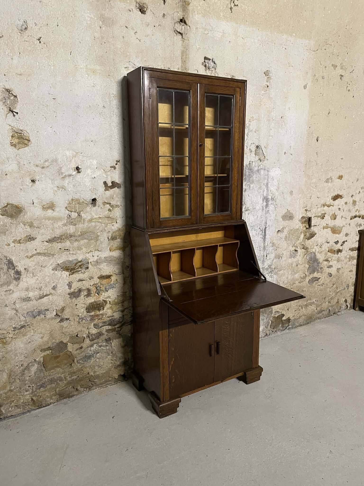 Oak display secretary cabinet with drop-down front, two sections.