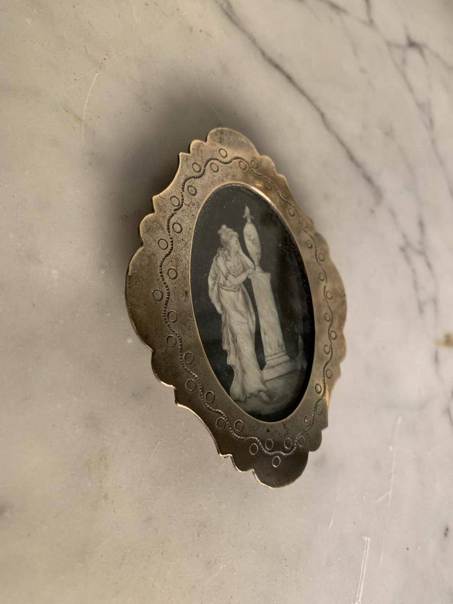 Miniature on ivory, oval brass frame.