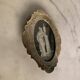 Miniature on ivory, oval brass frame.