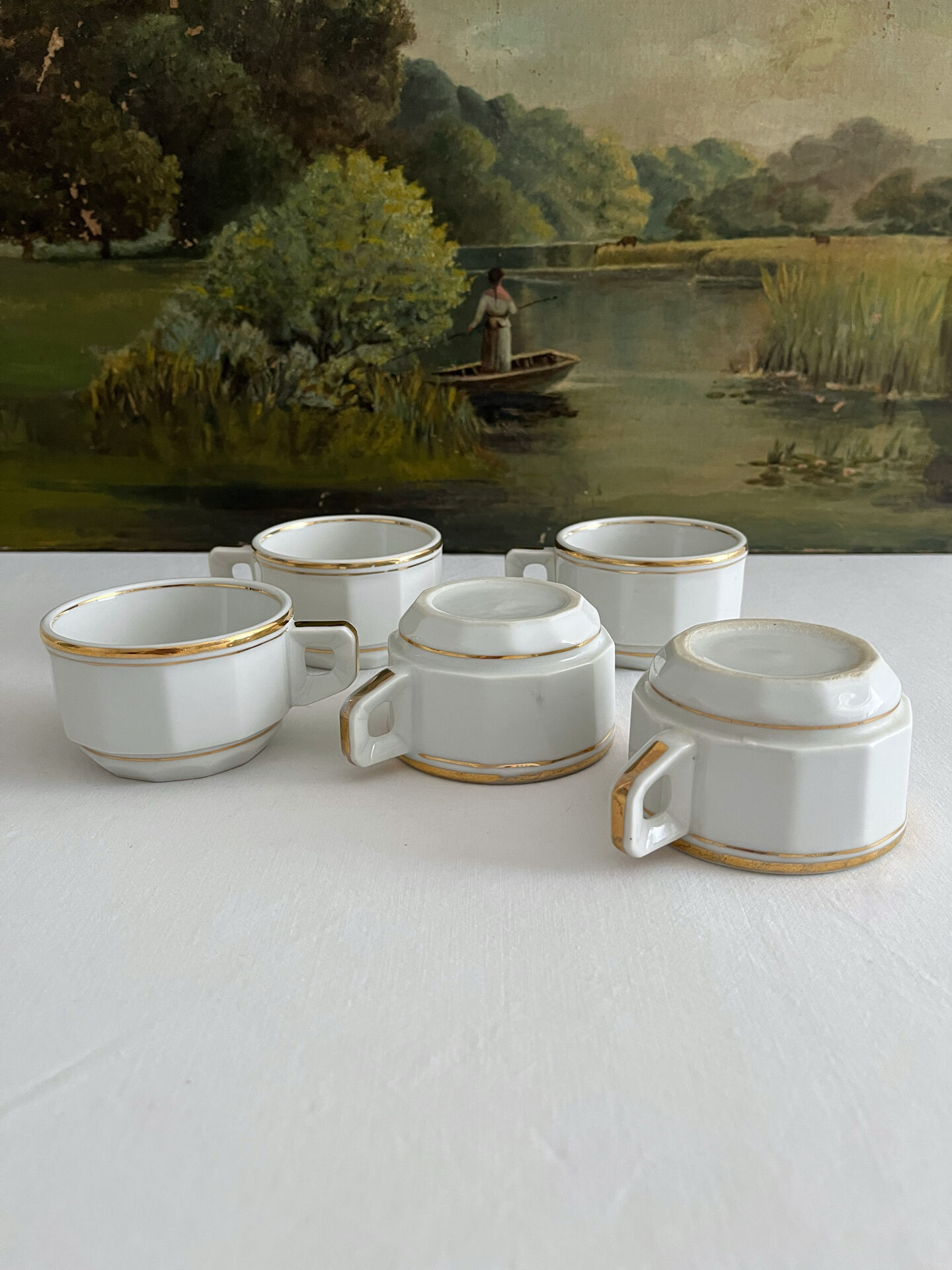 5 vintage porcelain bistro coffee cups from Paris with gold trim.