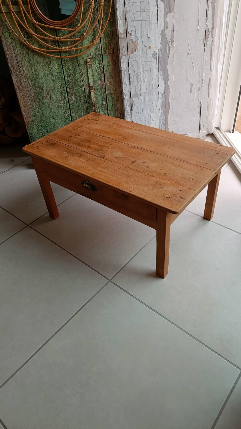 Coffee table with raw wood and a large drawer.