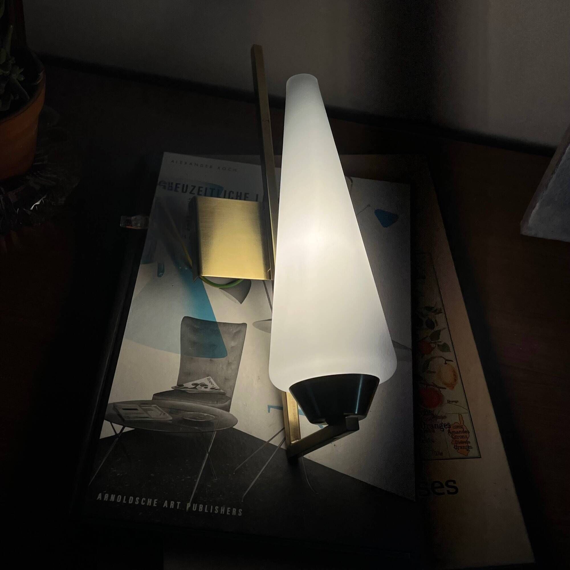 Vintage brass wall light with a white glass spindle shade from the 1950s-1960s.