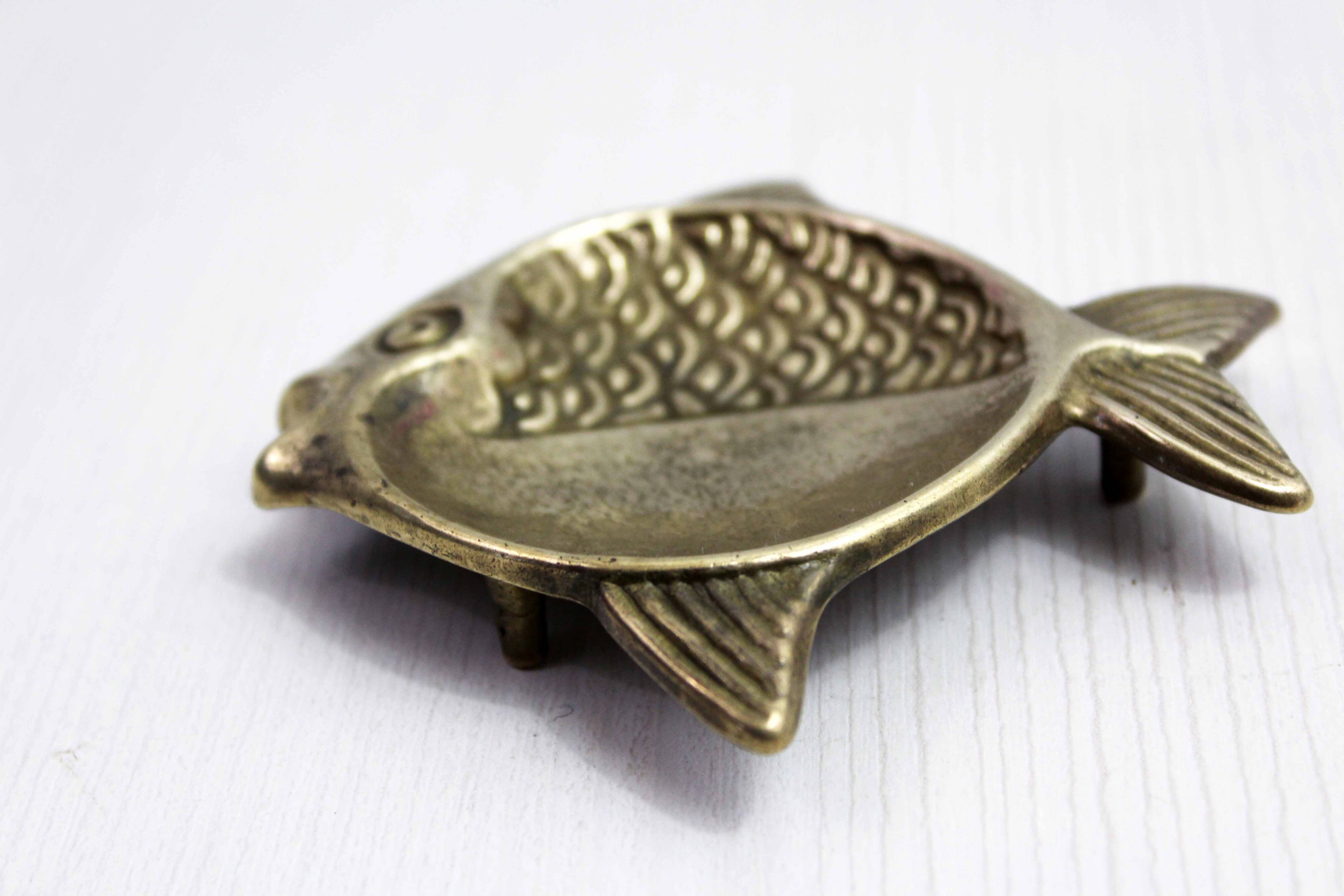 Vintage fish-shaped brass pocket emptier