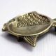 Vintage fish-shaped brass pocket emptier