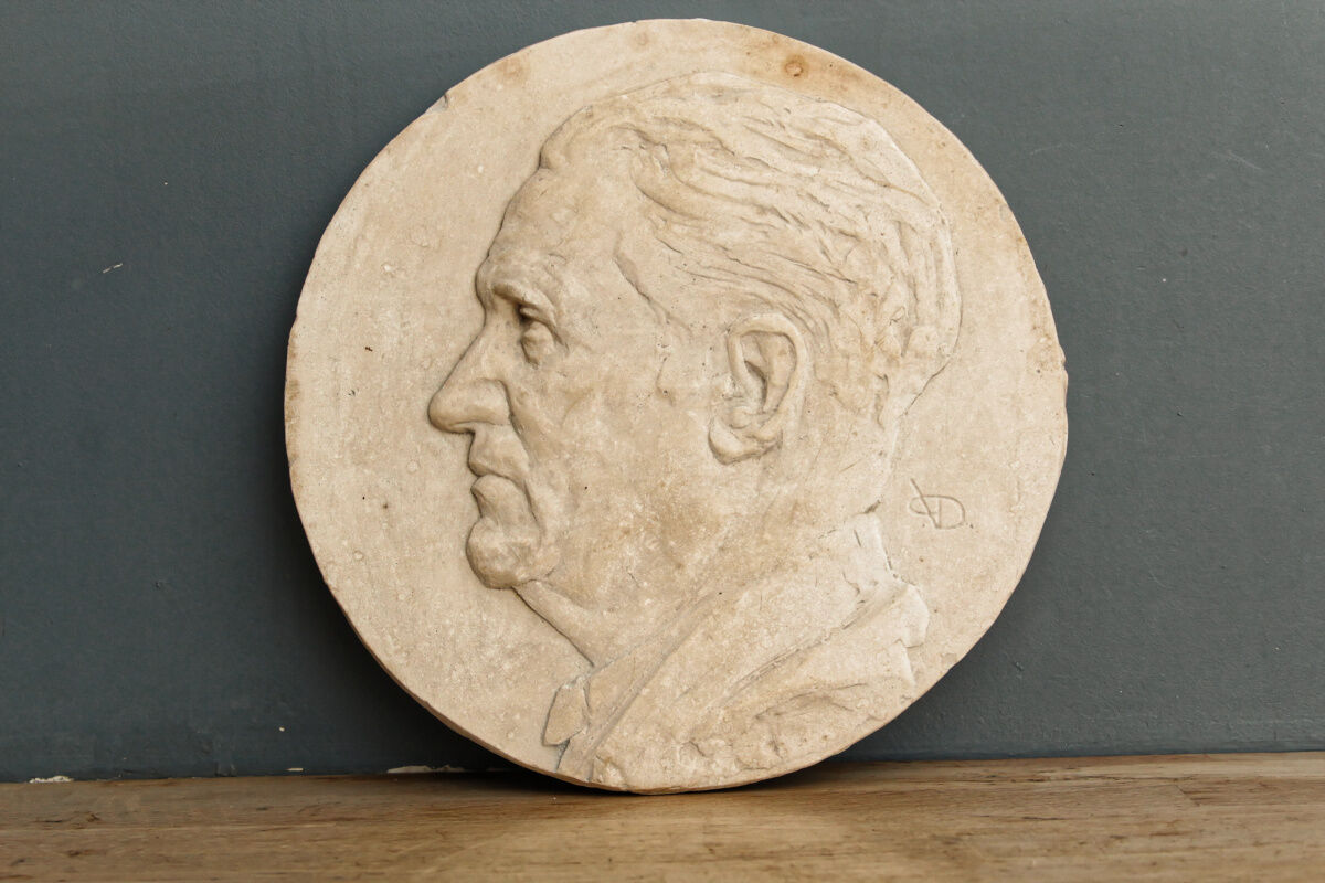 Old plaster medallion, man profile