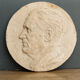 Old plaster medallion, man profile