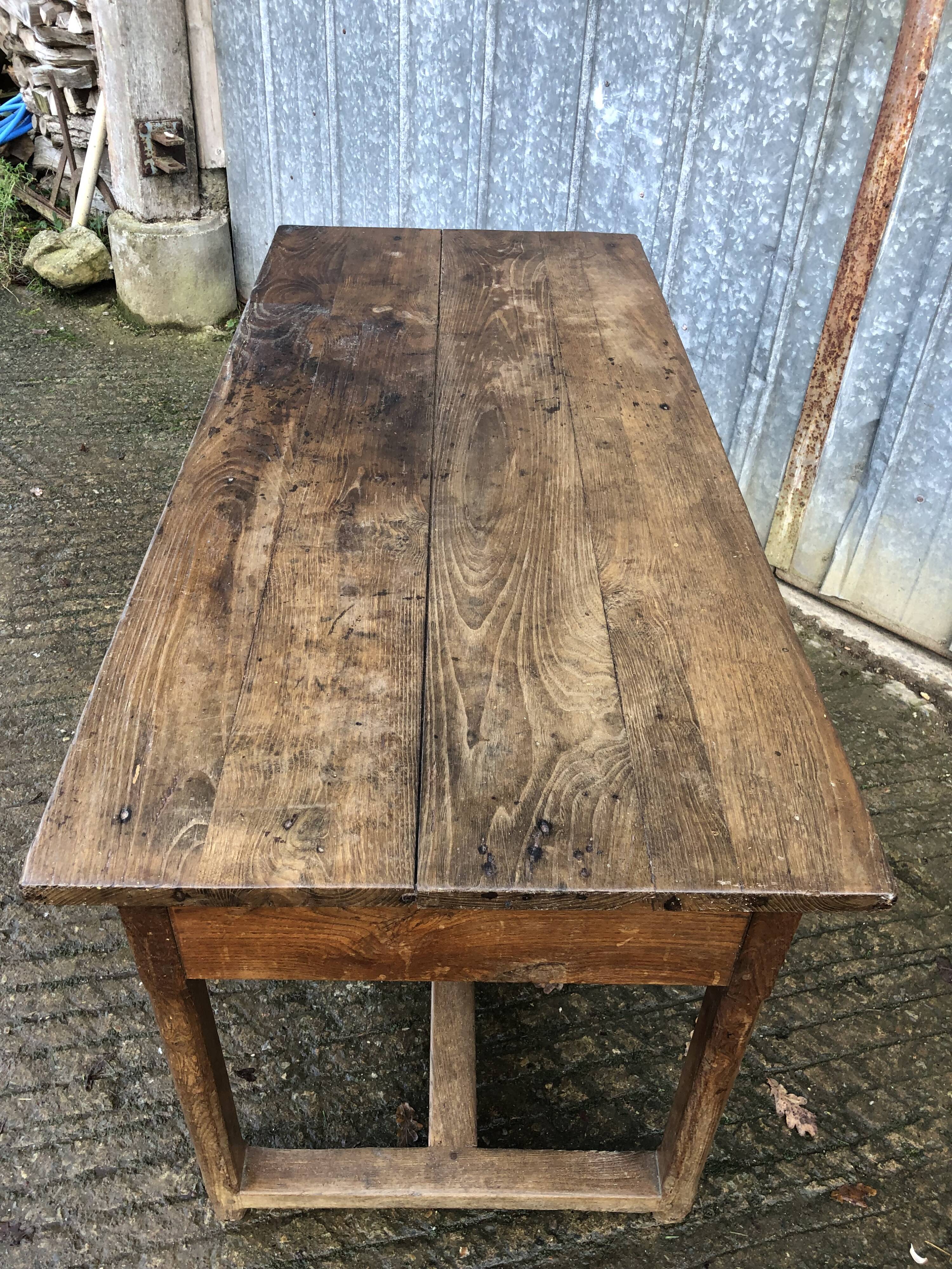 Old chestnut table with 3 front drawers and a cat bar.