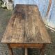 Old chestnut table with 3 front drawers and a cat bar.