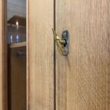 Glass-fronted school cabinet in raw oak