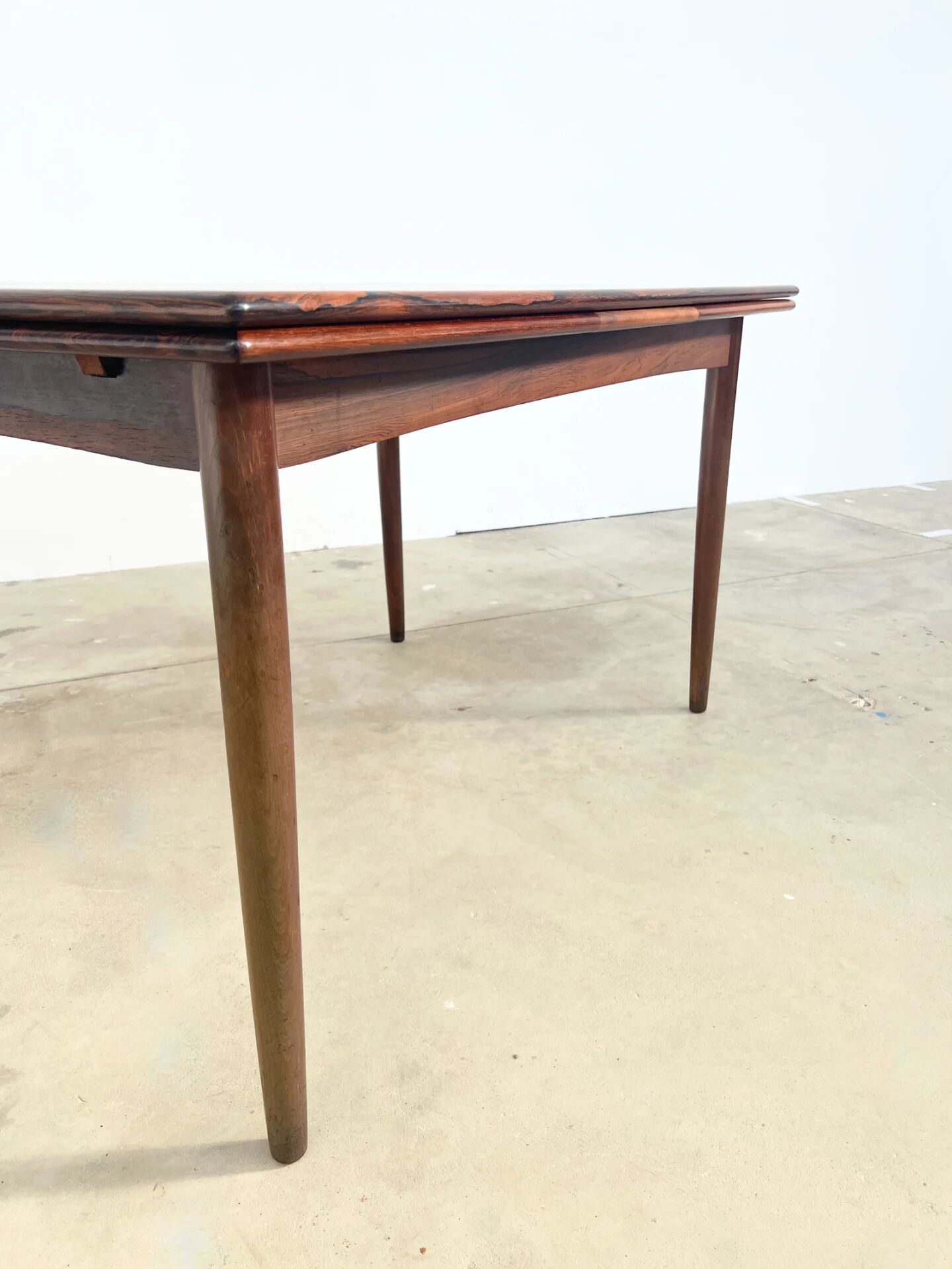 Rosewood dining table with integrated extensions — Denmark, 1960s