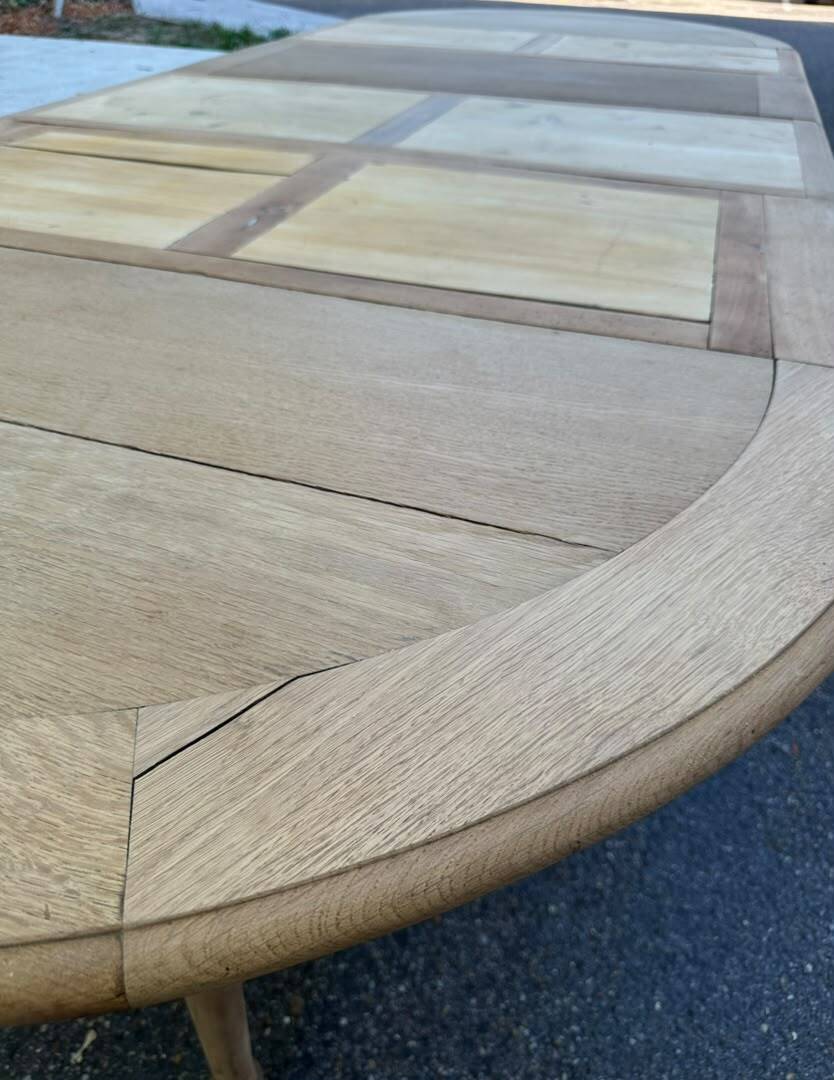 Round dining table with a central pedestal, stripped raw oak, 4 extensions, 19th century.