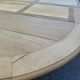 Round dining table with a central pedestal, stripped raw oak, 4 extensions, 19th century.