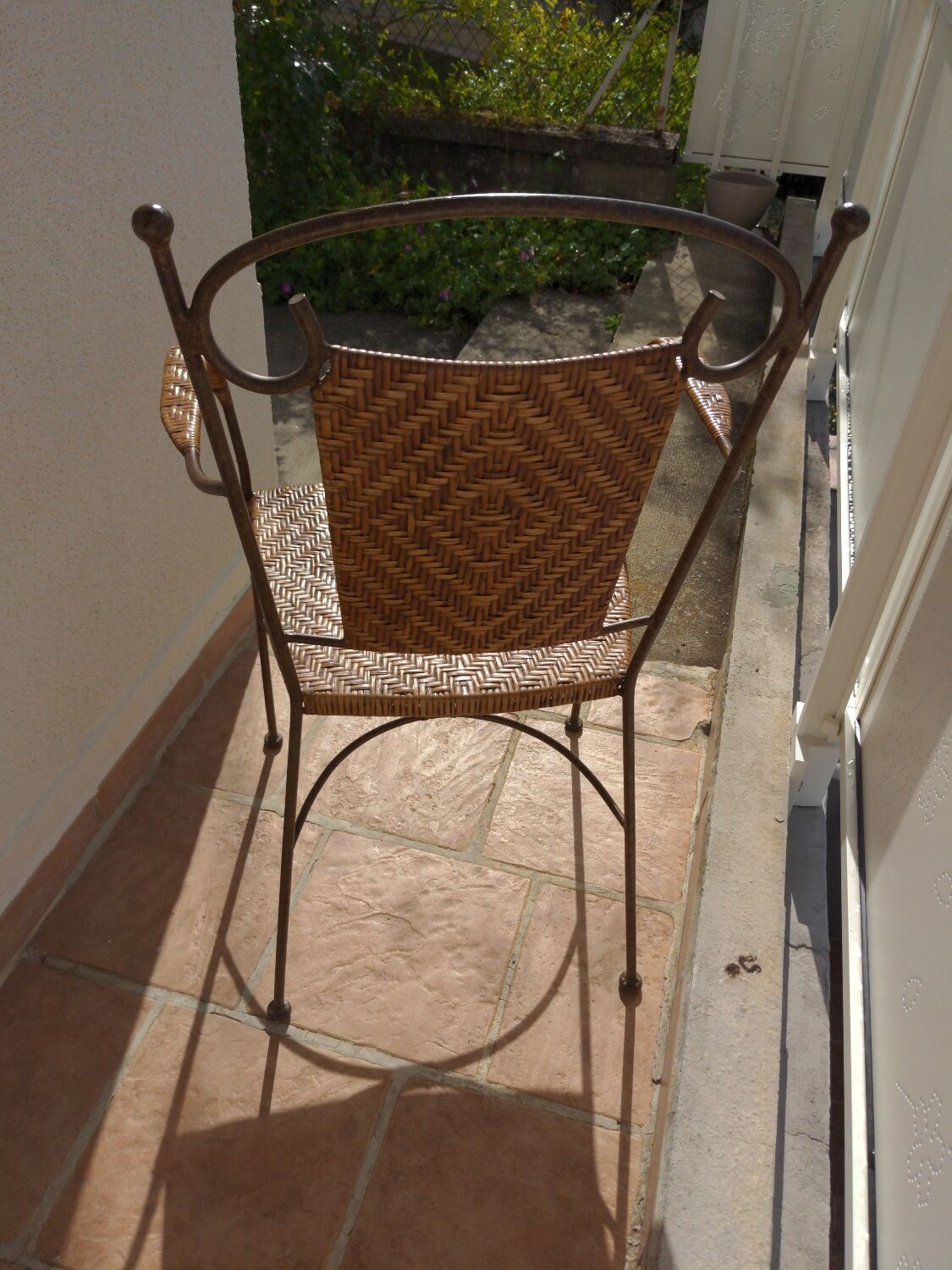 Wicker armchair and wrought iron