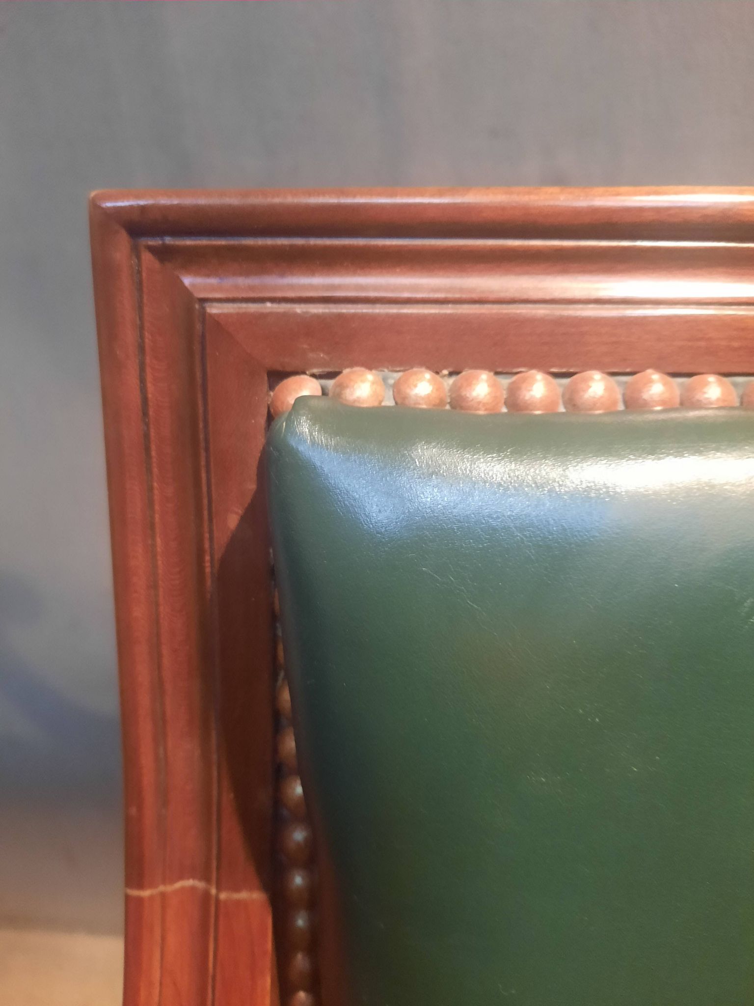 Pair of Louis XVI style armchairs upholstered in green leather.