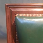 Pair of Louis XVI style armchairs upholstered in green leather.