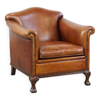 Sheepskin armchair with carved wooden legs