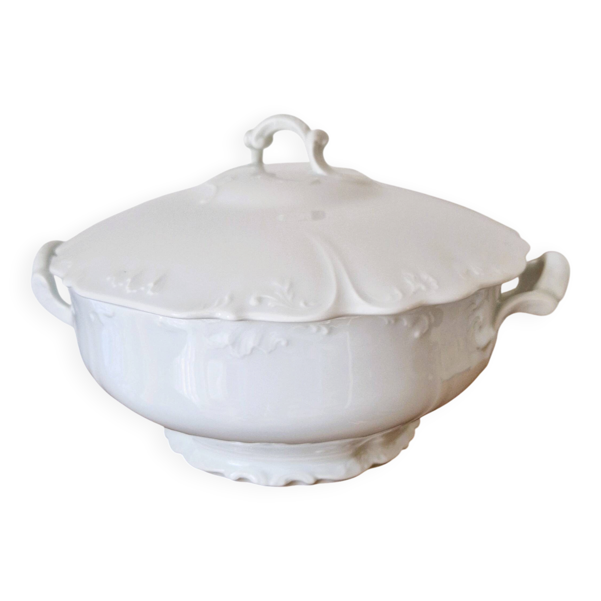 White porcelain soup tureen from Limoges with a vegetal scroll design.