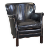 Subtle black armchair with reversible Kelim seat cushion