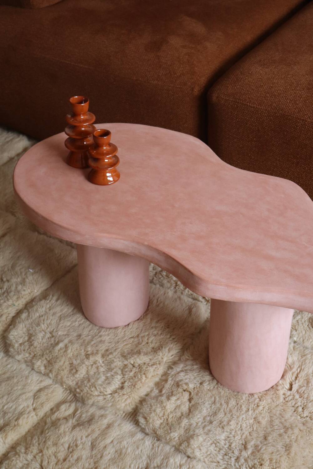 Organic shaped coffee table in pink teracotta tadelakt