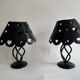 Pair of black wrought iron lanterns with heart patterns, romantic style.