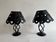 Pair of black wrought iron lanterns with heart patterns, romantic style.