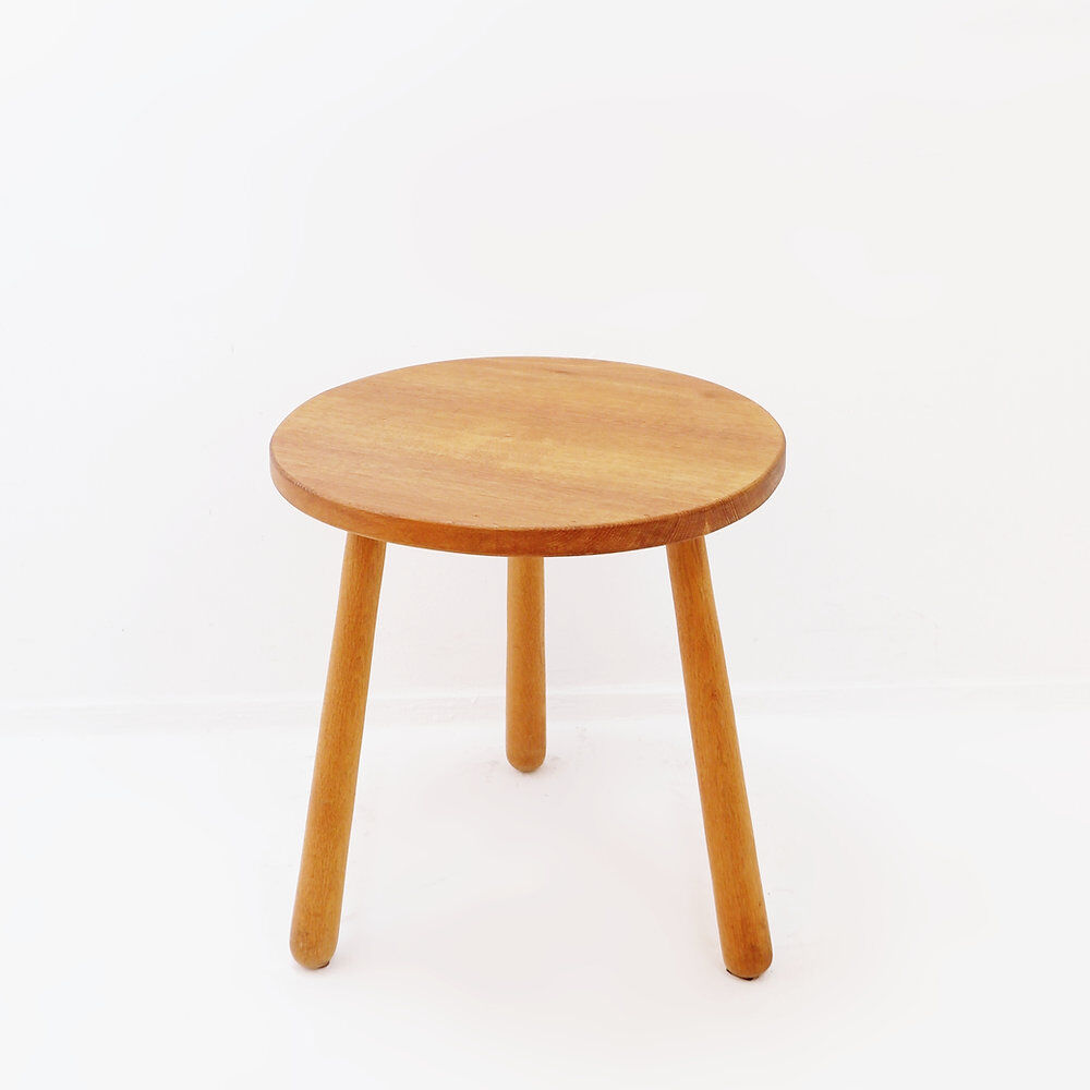 Vintage solid wood side table with rounded legs.